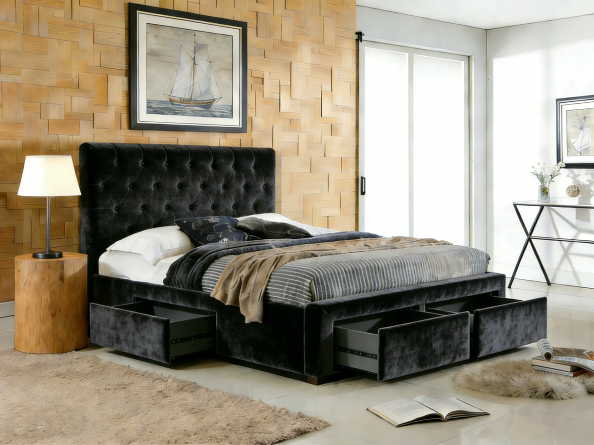 Modern bedroom with a black upholstered bed featuring storage drawers, wooden side table, and framed artwork on the wall.
