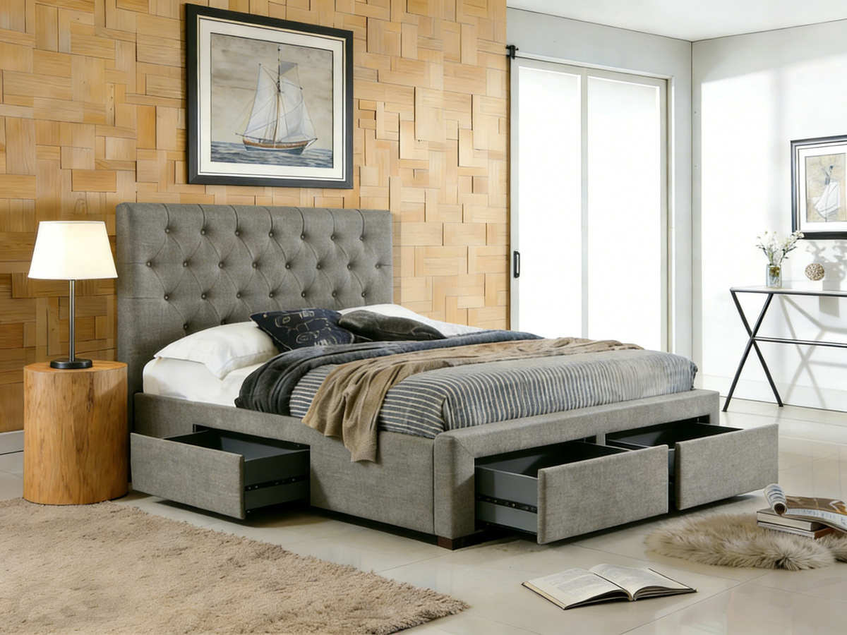 Gray upholstered bed with storage drawers in a bedroom setting.