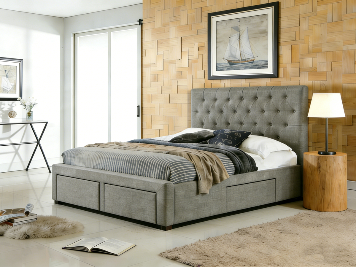 Gray upholstered bed in a modern bedroom with wooden walls and decor.