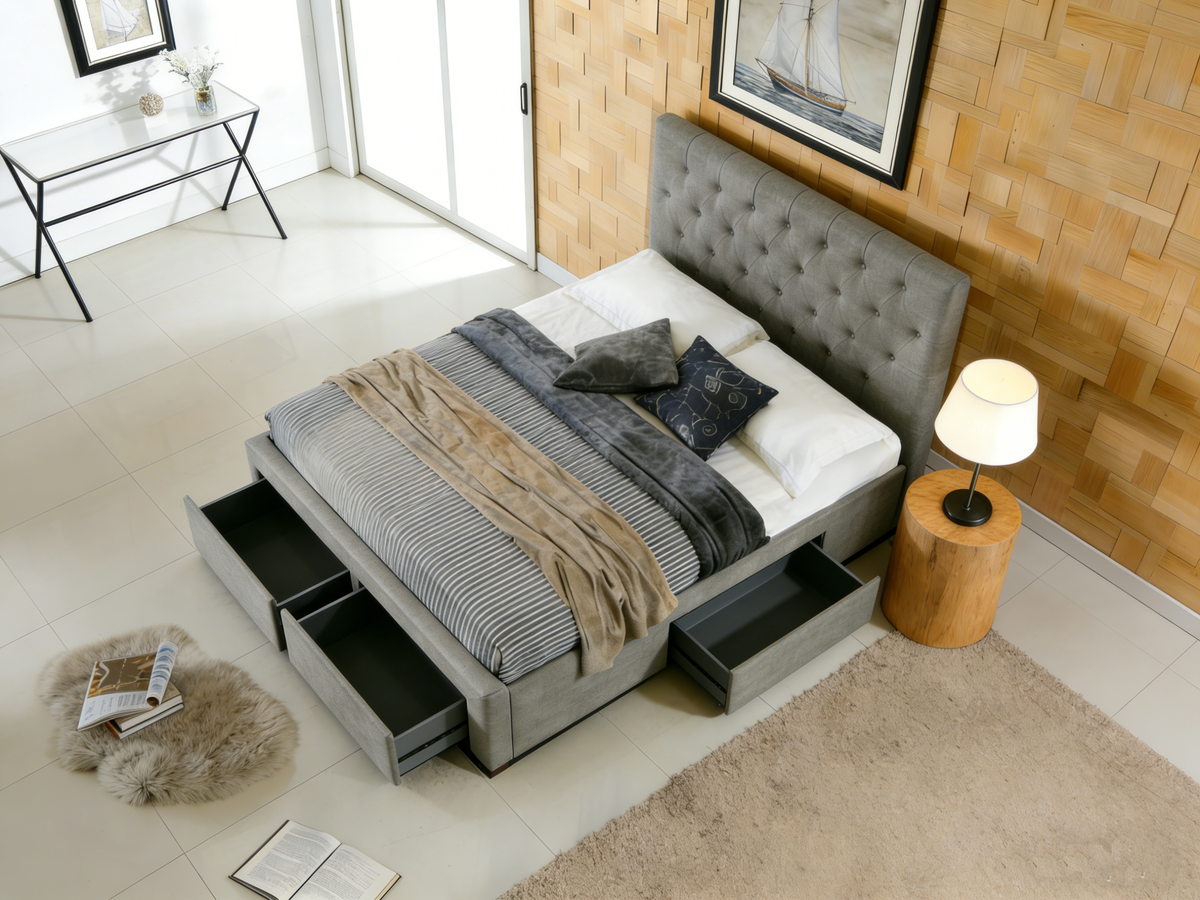 Gray upholstered bed with storage drawers in a modern bedroom setting.