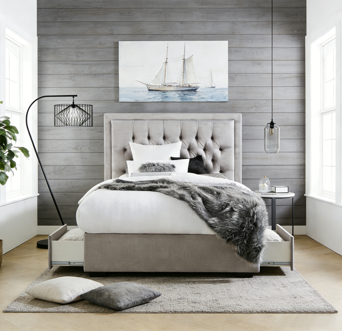 Modern bedroom with gray upholstered bed, white bedding, and decorative elements.