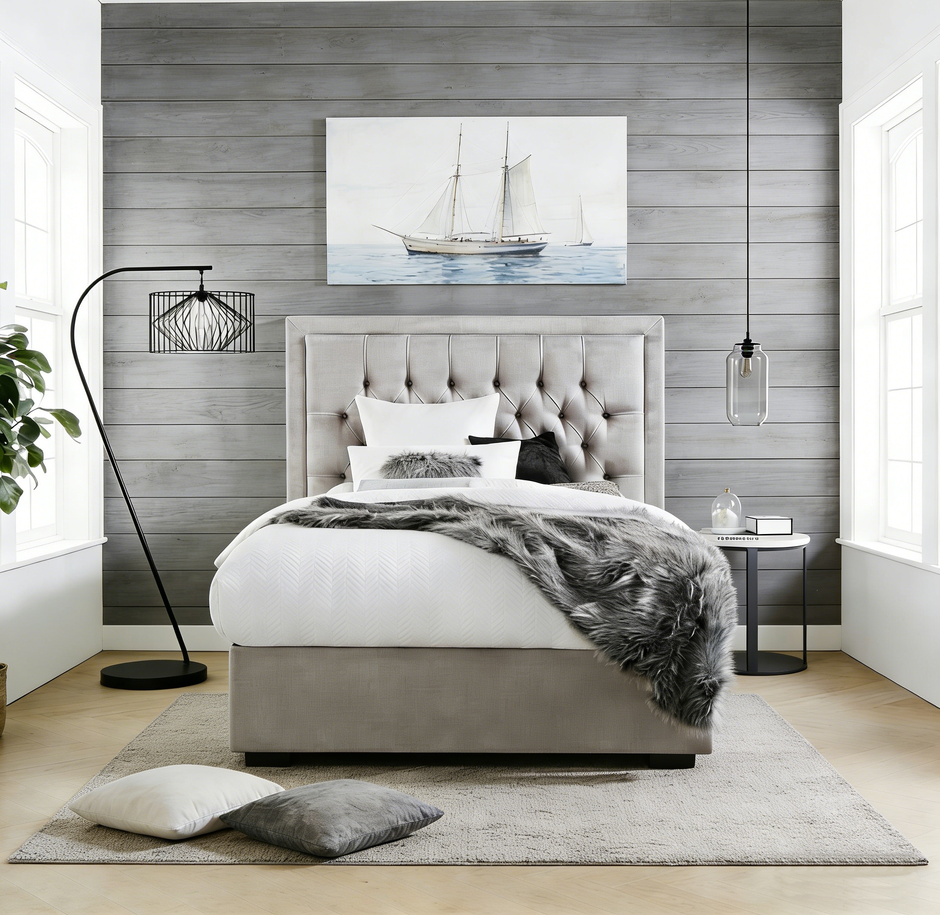 Modern bedroom with gray upholstered bed, white bedding, and decorative elements.