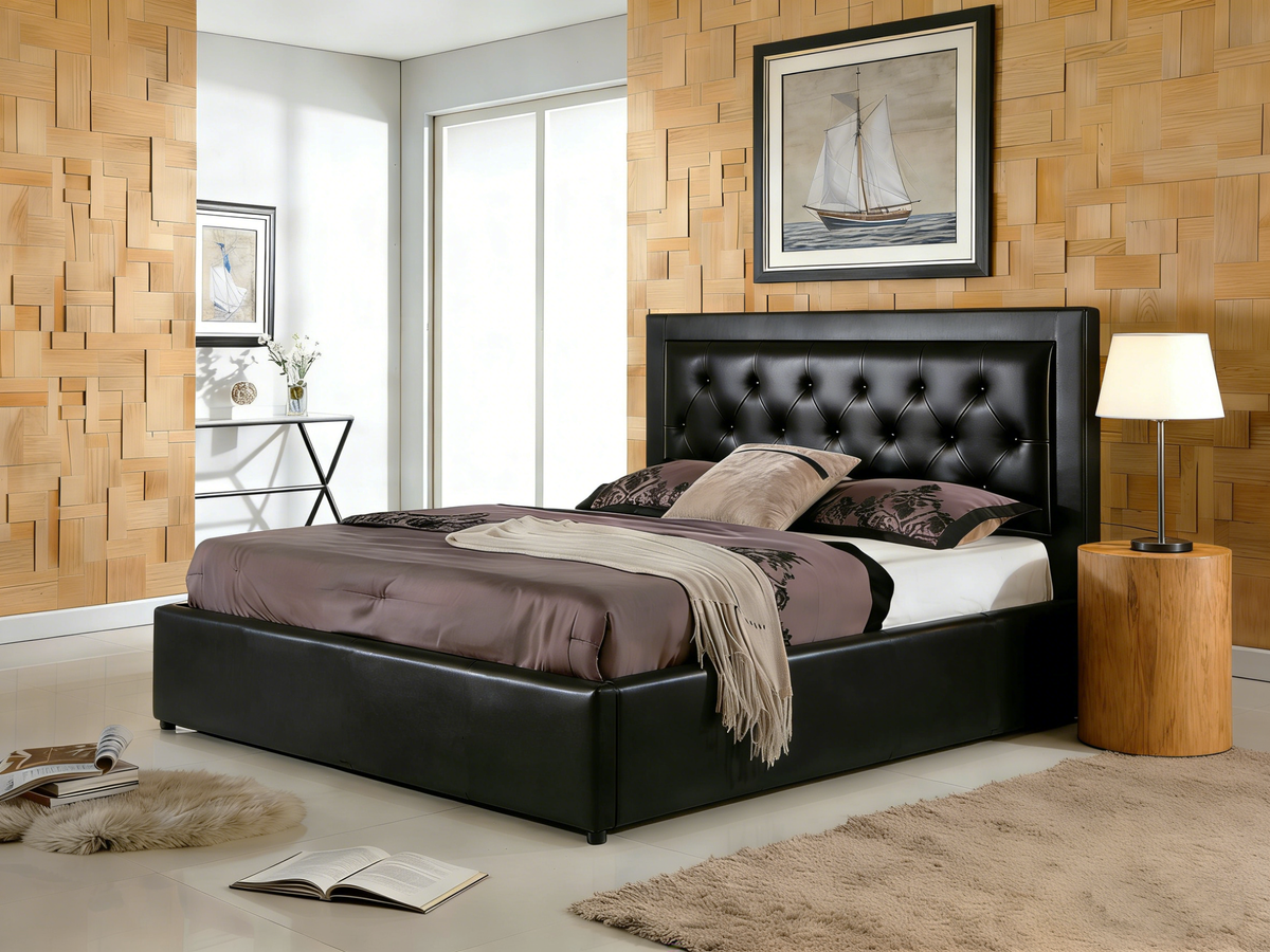 Modern bedroom with a black upholstered bed, wooden side table, and framed artwork on the wall.