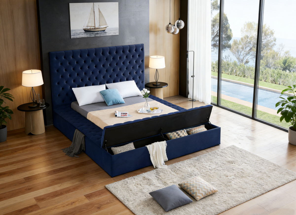 Modern bedroom with a blue upholstered bed, wooden flooring, and large windows.