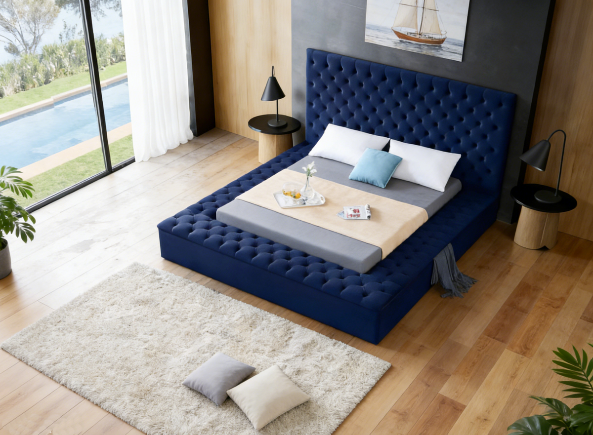 Modern bedroom with a blue tufted bed and wooden flooring.
