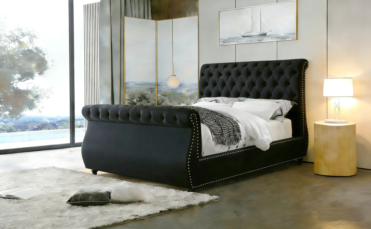 Modern bedroom with a black upholstered bed and side table.