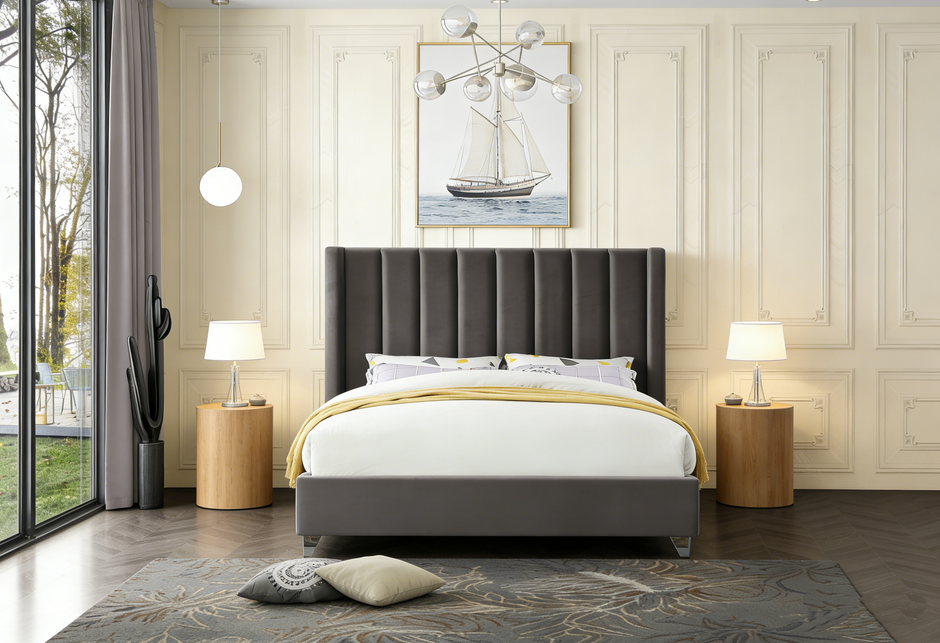 Modern bedroom with a gray upholstered bed, side tables, and a painting of a sailboat.