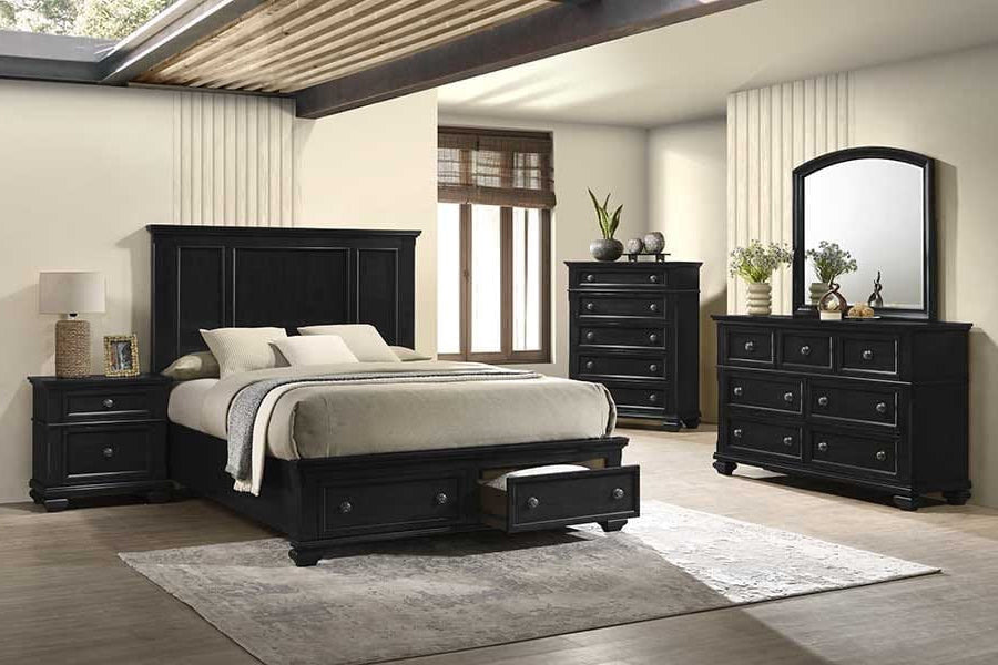 Black bedroom furniture set with bed, nightstands, dresser, and mirror in a room.