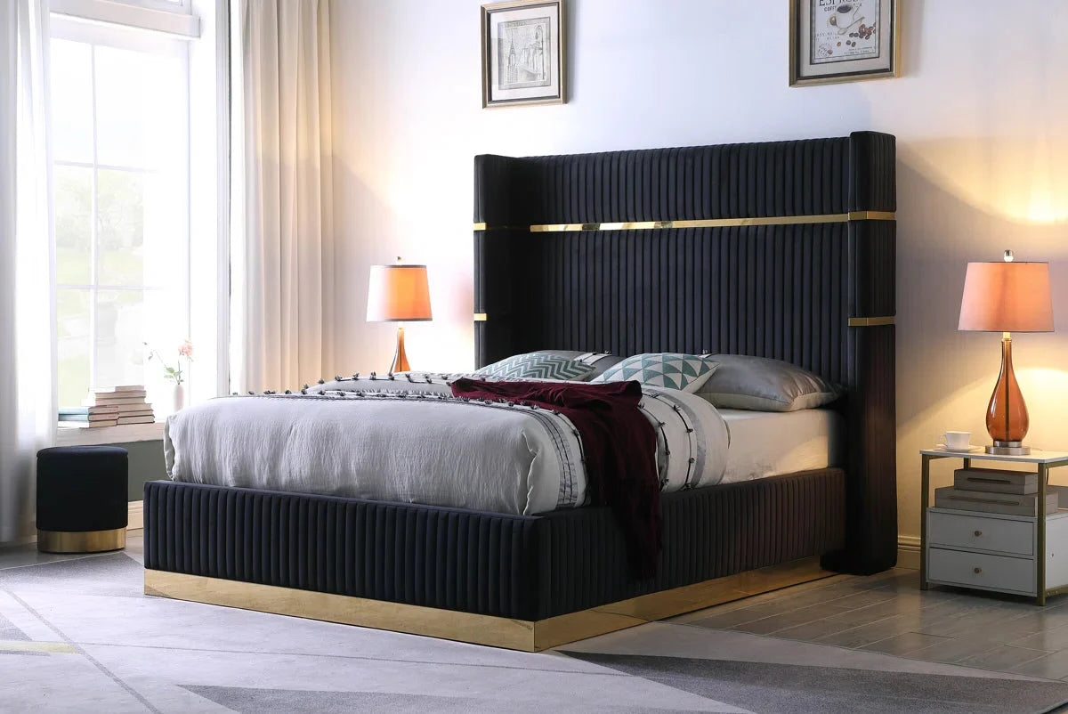 Modern bedroom with a black upholstered bed and matching headboard.