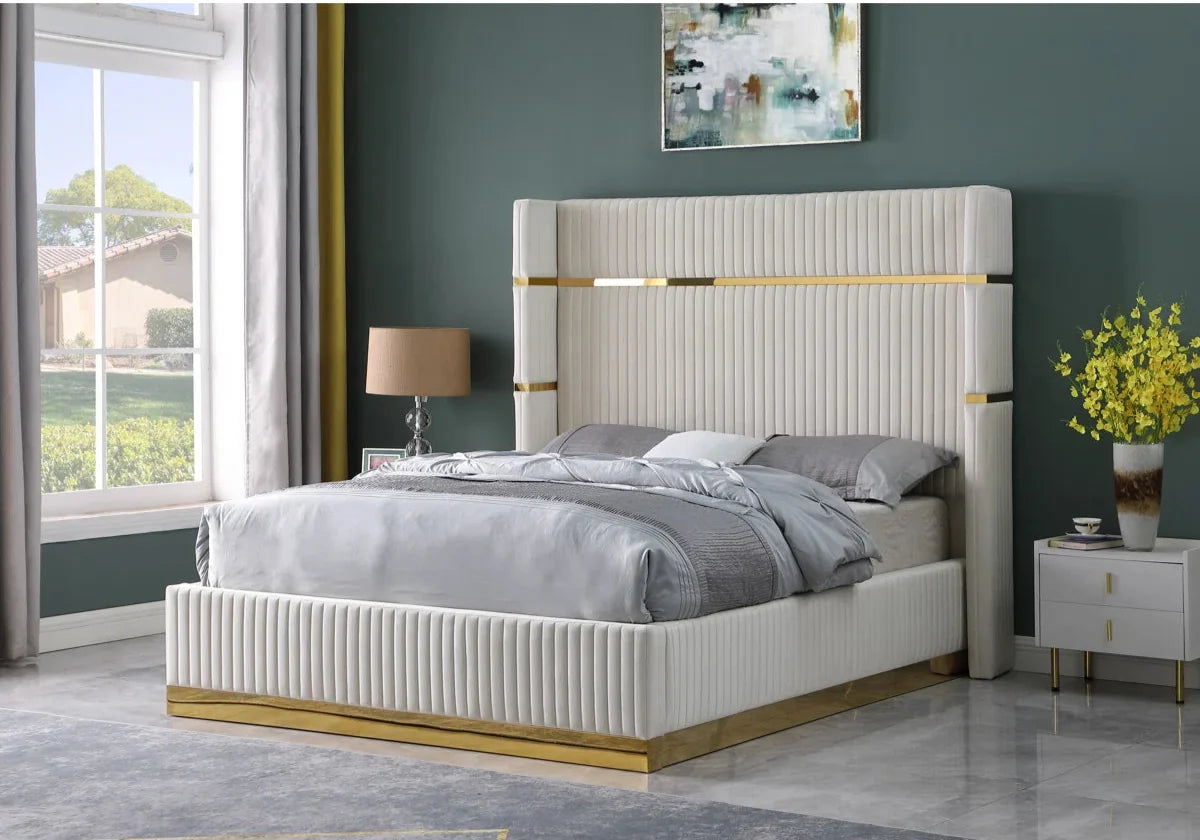 Modern bedroom with a white bed frame, gray bedding, and decorative elements.