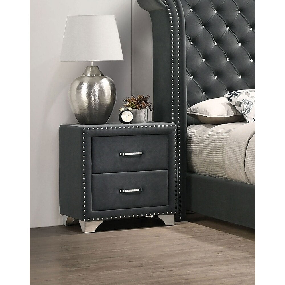 Gray nightstand with two drawers next to a bed with tufted headboard