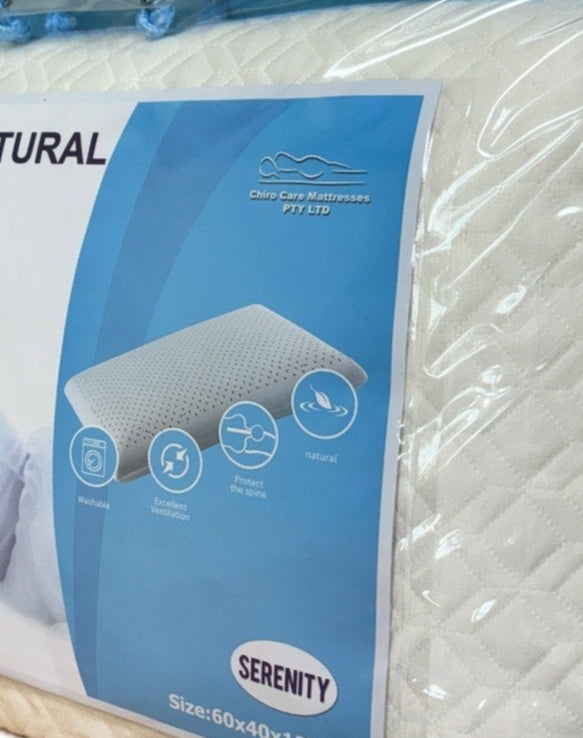Packaged luxurious natural latex pillow with blue and white label on a white background